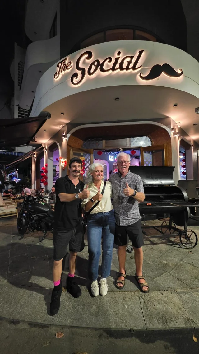 Guests outside The Social beneath the illuminated sign at 79 Ỷ Lan